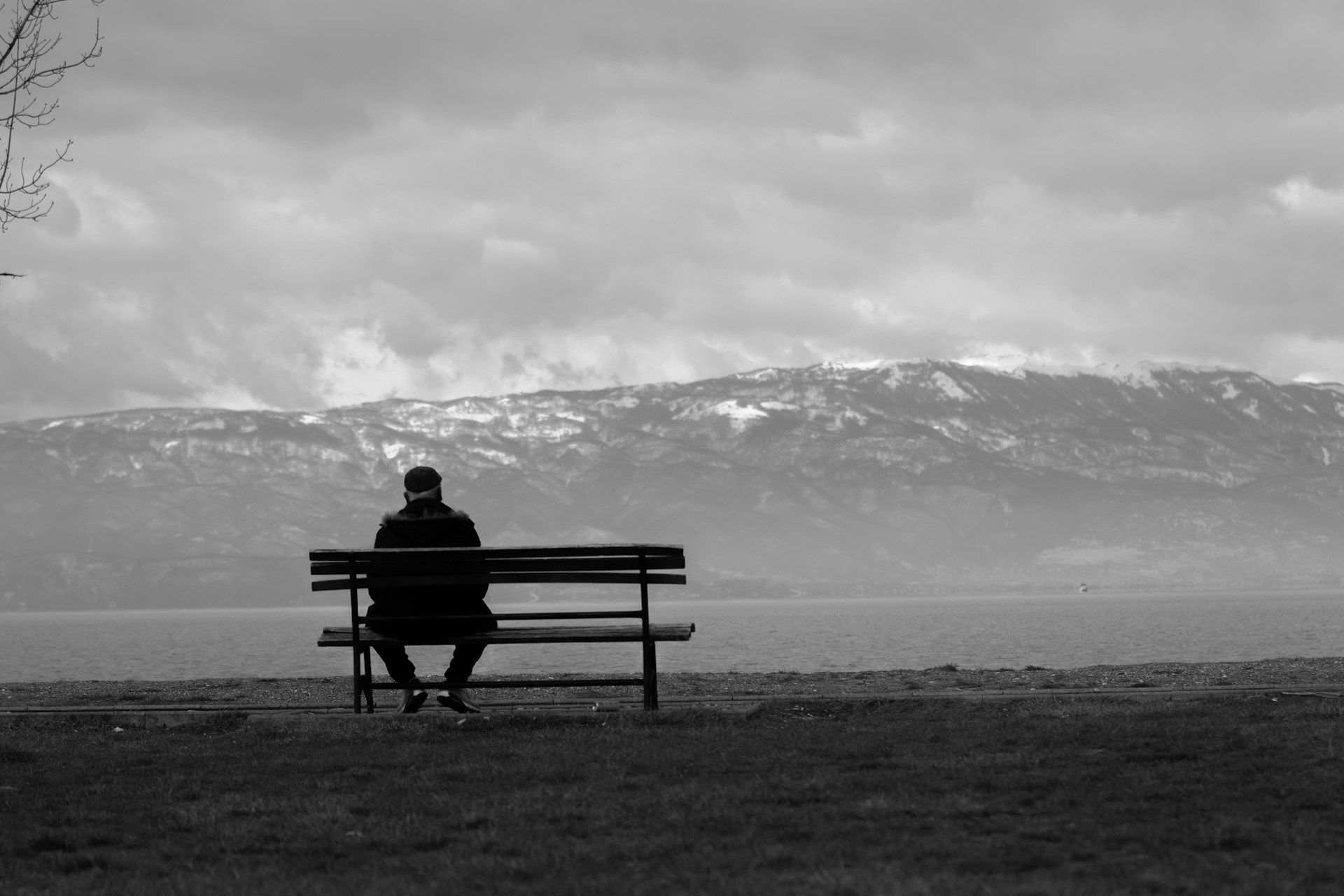 A man sits on a bench alone